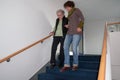 Caregiver helping senior woman walking down the stairs Royalty Free Stock Photo