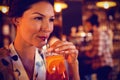 Young woman having cocktail drink Royalty Free Stock Photo