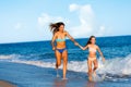 Young women having fun along beach. Royalty Free Stock Photo