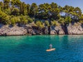 Young women Having Fun Stand Up Paddling in blue water sea in Montenegro. SUP. girl Training on Paddle Board near the Royalty Free Stock Photo