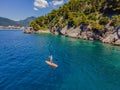Young women Having Fun Stand Up Paddling in blue water sea in Montenegro. SUP. girl Training on Paddle Board near the Royalty Free Stock Photo