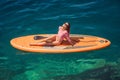 Young women Having Fun Stand Up Paddling in blue water sea in Montenegro. SUP. girl Training on Paddle Board near the Royalty Free Stock Photo