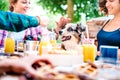 Young women on healthy pic nic breakfast with cute puppy at countryside farm house - Genuine life style concept Royalty Free Stock Photo