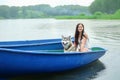 Young women and her dog husky resting near lake in summer
