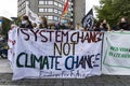 Young Women Holding Climate Change Banner at Demonstration