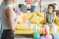 young women holding string with colorful party