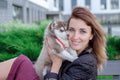 Young women holds her best friend little pet puppy of husky in her arms. love for dogs Royalty Free Stock Photo