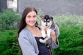 Young women holds her best friend little pet puppy of husky in her arms. love for dogs Royalty Free Stock Photo
