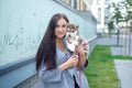 Young women holds her best friend little pet puppy of husky in her arms. love for dogs Royalty Free Stock Photo