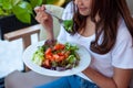 Young women intending to lose weight are eating a salmon vegetable salad for good health. Women choosing healthy food diet concept Royalty Free Stock Photo