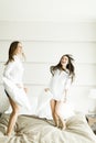 Young women jumping in the bed Royalty Free Stock Photo