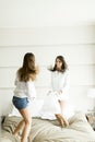 Young women jumping in the bed Royalty Free Stock Photo