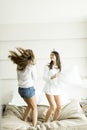 Young women jumping in the bed Royalty Free Stock Photo