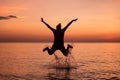 Young women jumping splashing water on the beach Royalty Free Stock Photo