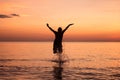 Young women jumping splashing water on the beach Royalty Free Stock Photo