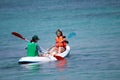 Young women kayaking down a sea