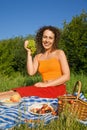 Young Women keeps in hand grape on picnic