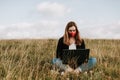 Young women with laptop in the nature, remote job, coronavirus 2020 Royalty Free Stock Photo