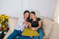 Young women laughing when looking at a cellphone Royalty Free Stock Photo