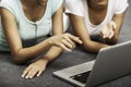 Young women laying while using laptop Royalty Free Stock Photo