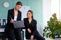 Young women leaders are checking financial statements from paper documents. Two female confident business worker dressed black Royalty Free Stock Photo