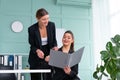 Young women leaders are checking financial statements from paper documents. Two female confident business worker dressed black Royalty Free Stock Photo