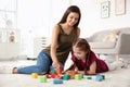 Young woman and little girl with autistic disorder playing