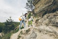 young woman with little toddler boy climbing by rocks Royalty Free Stock Photo