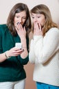 Young women looking at mobile cell phone Royalty Free Stock Photo