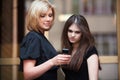 Young women looking at mobile phone Royalty Free Stock Photo