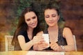 Young Women Looking at Smart Phone Screen Royalty Free Stock Photo