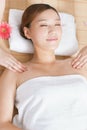 A young women lying in bed enjoying massage Royalty Free Stock Photo