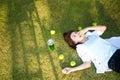 Young women lying in summer grass with eat apple Royalty Free Stock Photo