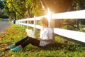 Young women lying in summer grass playing laptop and relax, sunny day, Royalty Free Stock Photo