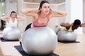 Young woman exercising with pilates ball during group class Royalty Free Stock Photo