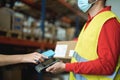 Young woman making contactless payment inside warehouse store during coronavirus outbreak - Focus on customer hand