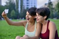 Young women making surprised face while looking at smart phone. Royalty Free Stock Photo