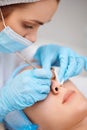 woman during a mechanical face cleansing procedure