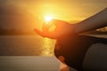 Young women meditate while doing yoga meditation, spiritual mental health practice with silhouette of lotus pose having peaceful Royalty Free Stock Photo