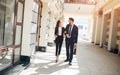 Young woman and man in fashion clothes holding their hands strolling Royalty Free Stock Photo