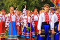Young women and men in national Ukrainian costumes and embroidered shirts go at the festival. Holiday City Day in Dnipro