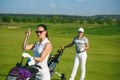 Young women and men playing golf Royalty Free Stock Photo