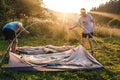 Woman and man putting up a tent.