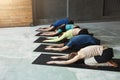 Young women and men in yoga class, relax meditation pose Royalty Free Stock Photo