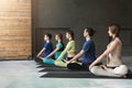 Young women and men in yoga class, relax meditation pose Royalty Free Stock Photo