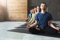 Young women and men in yoga class, relax meditation pose Royalty Free Stock Photo