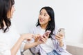 Young  women with mobile phones chatting at home Royalty Free Stock Photo