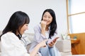 Young  women with mobile phones chatting at home Royalty Free Stock Photo