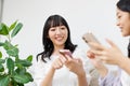 Young  women with mobile phones chatting at home Royalty Free Stock Photo