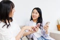 Young  women with mobile phones chatting at home Royalty Free Stock Photo